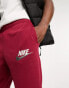 Nike Club Swoosh logo joggers in red