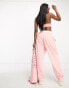 Фото #6 товара ASOS Design unisex co-ord relaxed joggers with prints in pink wash