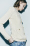 Knit cardigan with padded shoulders and rhinestone buttons