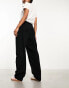 Monki tapered leg trousers with pleat front in black