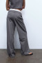 Turn-down waist trousers with topstitching