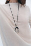 Cord necklace with circular pendant