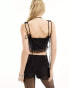 Lioness lace trim sleeveless tie front top in black