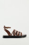 FLAT LEATHER SANDALS WITH CRISS-CROSS STRAPS