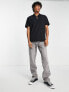 ASOS DESIGN relaxed fit polo with clasp detail in black