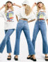 Фото #3 товара ASOS DESIGN mid rise cotton blend exaggerated flare jeans in midwash - MBLUE