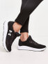 Under Armour Charged Pursuit 3 trainers in black and white