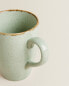 Porcelain mug with antique finish rim