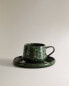 Green stoneware coffee cup and saucer