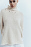 Sweater with rolled-up detail