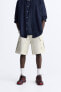 Ripped cargo bermuda shorts