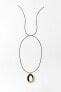 Cord necklace with circular pendant
