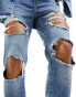 ASOS DESIGN power stretch jeans with all over rips in light wash blue