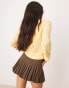 Фото #4 товара ASOS DESIGN crew neck cardigan in open stitch with bow detail in yellow