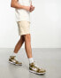 ASOS DESIGN oversized jersey shorts with poppers in beige