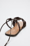 FLAT LACE-UP SANDALS WITH MULTIPLE STRAPS