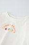 T-shirt with embroidered shoulder appliqué