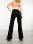 & Other Stories high waist flared leg jeans with button front detail and patch pockets in black