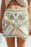 Embroidered mini skirt with mirrors