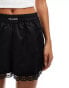 COLLUSION lace hem satin boxer short in black