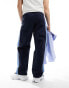 ASOS DESIGN baggy nylon track pants in navy with blue side stripe