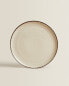 Porcelain dinner plate with antique finish rim