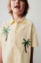 Embroidered sun and palm tree shirt