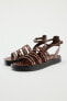 Flat leather sandals with criss-cross straps