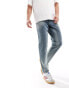 ASOS DESIGN tapered fit jeans with vintage tint in mid wash blue - MBLUE