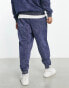 ASOS Actual relaxed joggers with piping and front print logo in washed blue