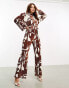 ASOS DESIGN plisse collared wide leg jumpsuit with tie waist in brown geo print