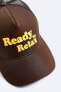 Cap with raised slogan