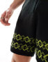 ASOS DESIGN co-ord knitted shorts in black with green border