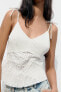 Contrast knit top with cutwork embroidery