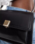 Accessorize crossbody bag with gold clasp in black