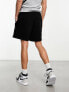 ASOS DESIGN oversized jersey shorts with poppers in black