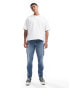 Фото #1 товара ASOS DESIGN tapered jeans with abrasions in midwash blue