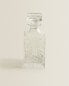 Crystalline bottle with raised design