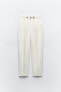 Trousers with gold buttons