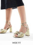 Фото #1 товара ASOS DESIGN Wide Fit Hitched bow detail mid block heeled sandals in gold