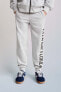 Jogging trousers with flocked slogan