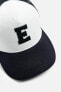 CAP WITH RAISED LETTER