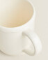 Earthenware mug with a raised-design edge