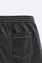 Swimming trunks with contrast topstitching