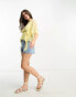 ASOS DESIGN Petite dobby wrap short sleeve blouse with pleated peplum hem in lemon