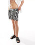 ASOS DESIGN swim shorts in mid length in black wave print