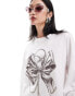 Monki long sleeve relaxed fit top with bow print in white