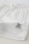 Plush bermuda shorts with label detail