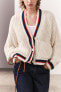 Knit jacket with piped seams