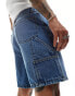 ASOS DESIGN standard length denim jorts with carpenter detailing in mid wash blue